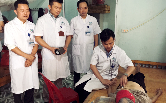 Các y, bác sỹ Trung tâm Y tế Yên Bình kiểm tra sức khỏe cho mẹ Việt Nam anh hùng Dương Thị Cúc, thôn Ngòi Bang, xã Bảo Ái.