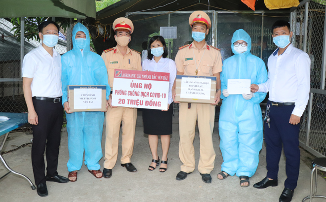 Lãnh đạo Phòng CSGT, Công an tỉnh Yên Bái cùng lãnh đạo Ngân hàng Nông nghiệp và Phát triển Nông thôn Chi nhánh Bắc Yên Bái tặng quà Chốt kiểm dịch số 6 xã Minh Quân (Trấn Yên)