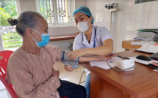 Local residents in Bao Hung commune receive health care services at the communal health care station.
