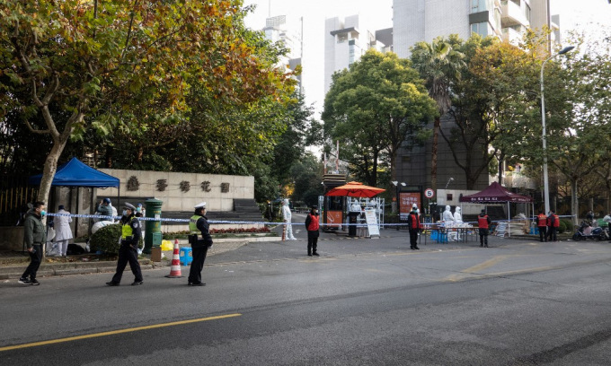 Cảnh sát, nhân viên y tế ngoài khu dân cư bị phong tỏa ở Thượng Hải, Trung Quốc, hôm 26/11.