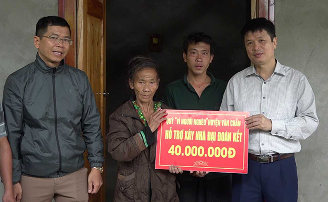 Lãnh đạo Ủy ban Mặt trận Tổ quốc huyện Văn Chấn trao tiền hỗ trợ làm nhà cho hộ nghèo tại xã Suối Giàng.