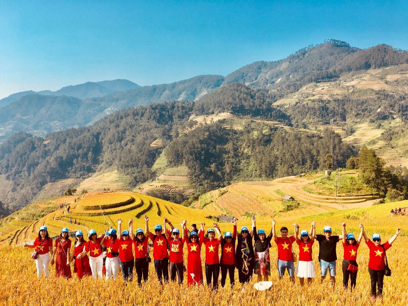 Tourists enjoying the golden rice terrace season in Mu Cang Chai.