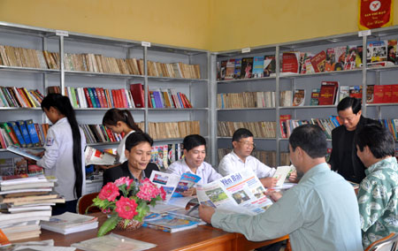 Người dân đọc sách, báo tại thư viện thị trấn Yên Thế.