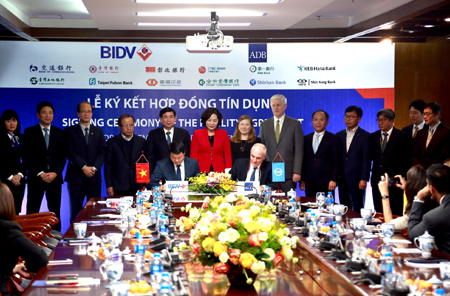 Ông Lê Ngọc Lâm - Phó Tổng Giám đốc phụ trách Ban Điều hành BIDV (tay trái) và ông Michael Barrow - Vụ trưởng Vụ Hoạt động khu vực tư nhân của ADB đại diện hai đơn vị ký kết Hợp đồng tín dụng.
