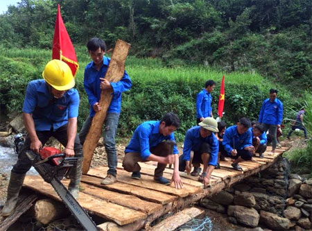 Đoàn viên Huyện đoàn Mù Cang Chải làm cầu qua khe suối tại bản Pú Nhu, xã La Pán Tẩn khắc phục hậu quả cơn bão số 3.