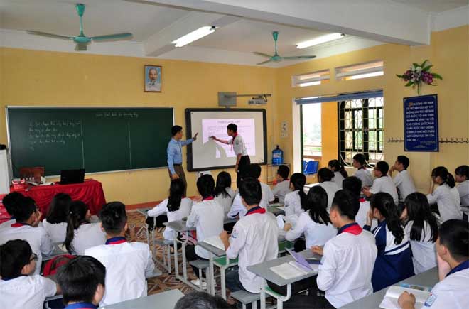 Giáo viên hướng dẫn học sinh tương tác trên bảng thông minh trong một giờ học ở Trường THCS Lê Hồng Phong.