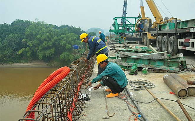 Công nhân Công ty TNHH Thương mại và Xây dựng Trung Chính thi công hệ mặt cầu Cổ Phúc.