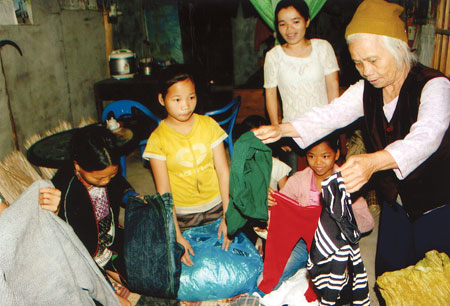 Bà Doan chia quần áo cho người nghèo thôn Đồng Tha.
