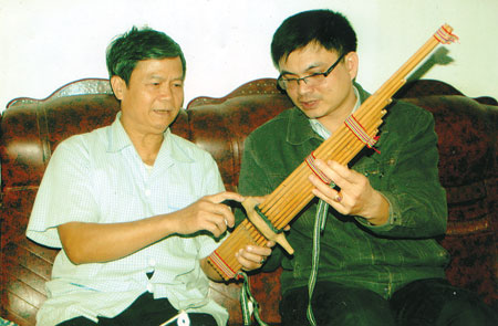 Ông Cầm Văn Long giới thiệu với phóng viên Báo Yên Bái về cấu tạo của khèn bè.