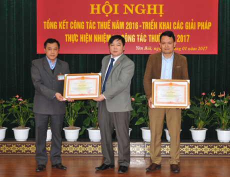 Thừa ủy quyền của Thủ tướng Chính phủ, đồng chí Nông Xuân Hùng - Cục trưởng Cục Thuế tỉnh Yên Bái trao Bằng khen của Chính phủ cho 2 cá nhân.