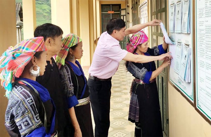Cán bộ Phòng Giao dịch Ngân hàng Chính sách xã hội huyện Mù Cang Chải hướng dẫn người dân làm thủ tục vay vốn.