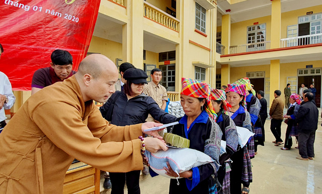 Đại đức Thích Minh Huy - Phó trưởng Ban Thường trực Ban Trị sự Giáo hội Phật giáo Việt Nam tỉnh Yên Bái, Trụ trì chùa Tùng Lâm - Ngọc Am tặng quà cho các hộ nghèo ở xã La Pán Tấn, huyện Mù Cang Chải