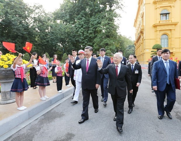 Party General Secretary and State President  Nguyen Phu Trong (C) and his Chinese counterpart Xi Jinping on his right at a welcome ceremony for the Chinese leader's State visit to Vietnam in 2017.