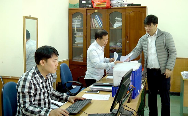Cán bộ, công chức phòng nghiệp vụ của cơ quan Ủy ban Kiểm tra Tỉnh ủy trao đổi hồ sơ kiểm tra. (Ảnh: Quang Tuấn)