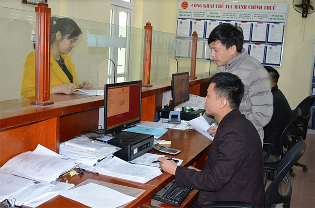 Cán bộ Chi cục Thuế huyện Văn Yên hướng dẫn người nộp thuế.