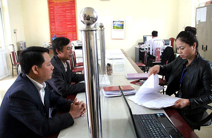 Cán bộ Bộ phận một cửa xã Đại Minh, huyện Yên Bình giải quyết công việc cho công dân.