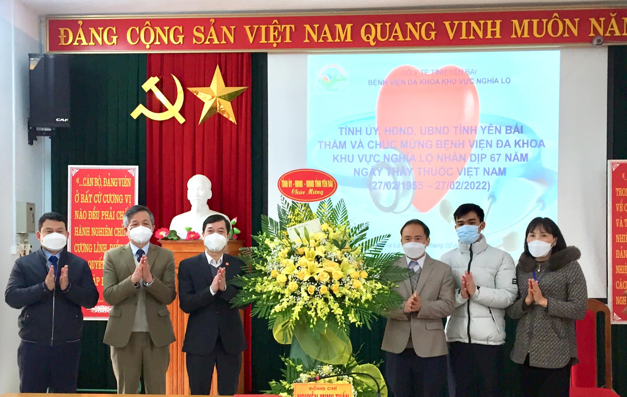 Trưởng Ban Tuyên giáo Tỉnh ủy Nguyễn Minh Tuấn tặng hoa chúc mừng các y, bác sỹ, cán bộ, nhân viên Bệnh viện Đa khoa khu vực Nghĩa Lộ.