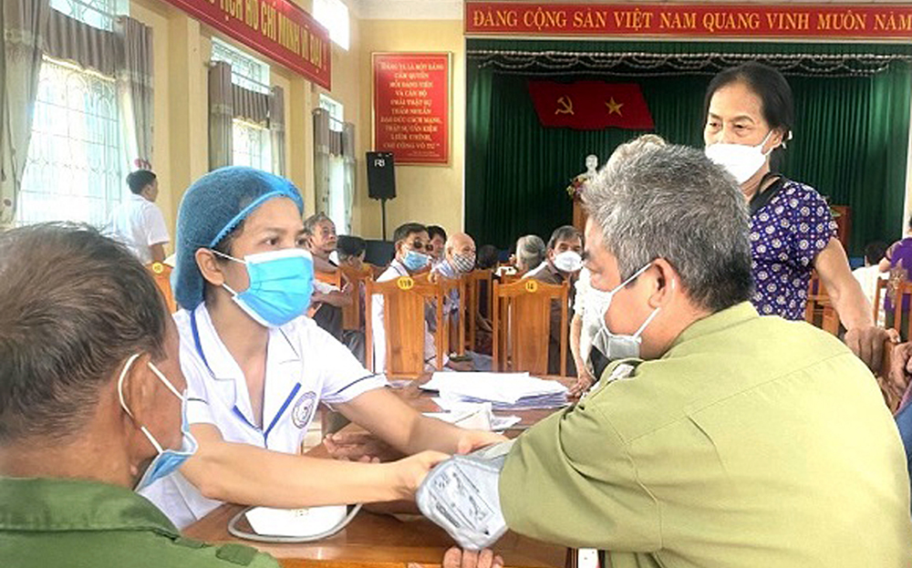 Cán bộ Trạm Y tế thị trấn Cổ Phúc kiểm tra và cấp thuốc điều trị huyết áp cho bệnh nhân.