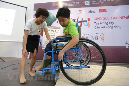 Trẻ em tham gia đóng vai người khuyết tật ngồi xe lăn để cảm nhận được những khó khăn của họ trong cuộc sống.