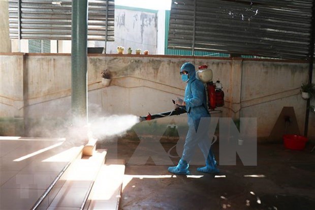 Spraying disinfectant at an exercise on responding to a COVID-19 outbreak .