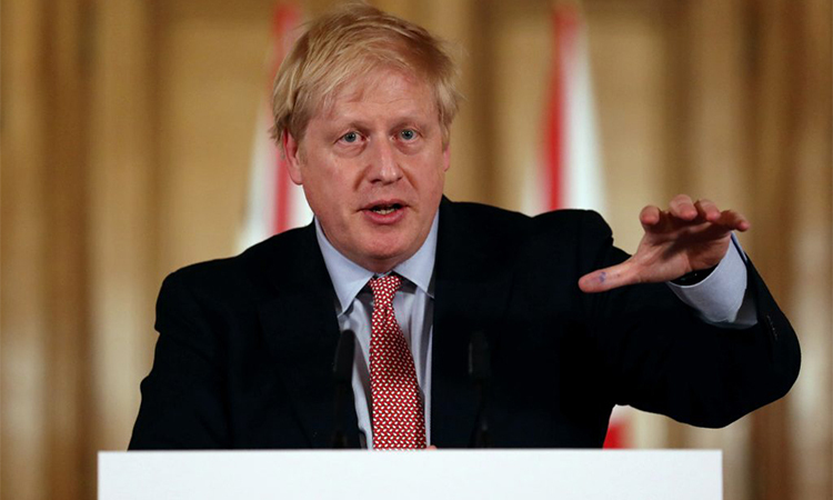 Thủ tướng Anh Boris Johnson tại một cuộc họp báo về phản ứng của chính phủ với Covid-19 ở London hôm 12/3.