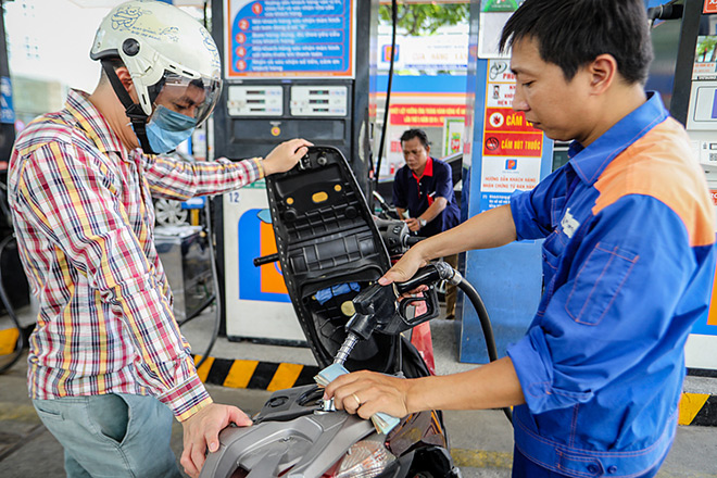 Nhân viên Petrolimex bán xăng dầu cho khách.