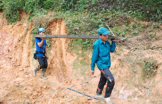 Các chiến sĩ dân quân huyện Mù Cang Chải giúp dân khắc phục hậu quả thiên tai.