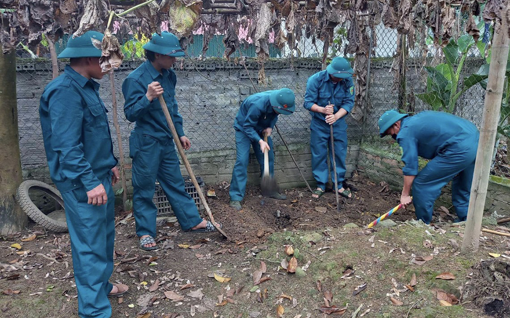 Hội viên cựu chiến binh xã Tân Hợp giúp gia đình chính sách đào hố rác bảo đảm vệ sinh môi trường.