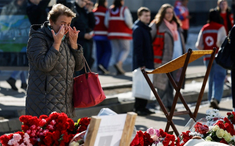 Một người dân xúc động tại điểm tưởng niệm các nạn nhân gần Nhà hát Crocus City Hall, vùng Matxcơva (Nga) ngày 27-3