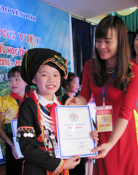 Bà Nguyễn Thị Thúy Hằng - Trưởng phòng Giáo dục tiểu học, Sở GD&ĐT  trao giải nhất cá nhân cho em Triệu Huyền Trang.

