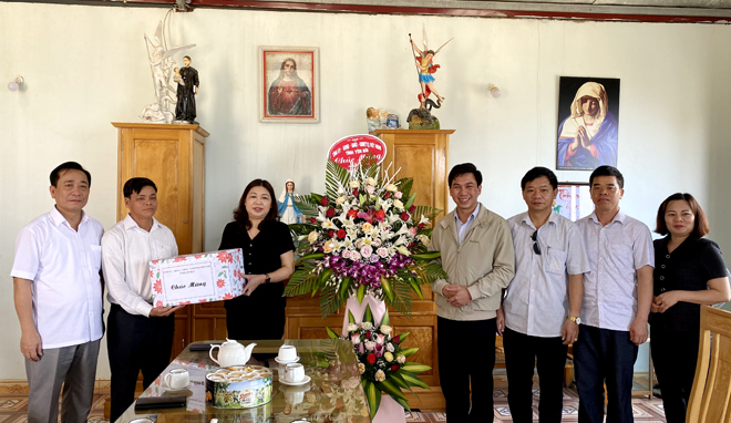 Thay mặt lãnh đạo tỉnh, đồng chí Hoàng Thị Vĩnh tặng hoa và quà chúc mừng Giáo xứ Phình Hồ nhân Lễ Phục sinh