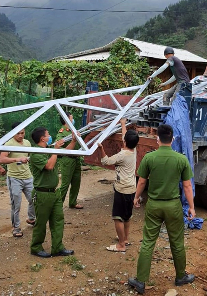 Cán bộ, chiến sĩ Công an xã Xà Hồ, huyện Trạm Tấu giúp dân tu sửa nhà ở.