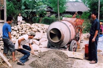 Trưởng khu Lò Văn Cấp (bên phải) đang chỉ đạo bà con thi công đường giao thông trong khu phố.
