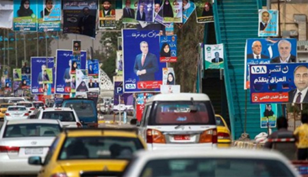 Các poster cổ động bầu cử trên đường phố Najaf, Iraq.