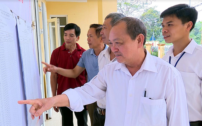 Cử tri xã Minh Bảo, thành phố Yên Bái nghiên cứu danh sách các ứng cử viên trước khi bỏ phiếu bầu cử