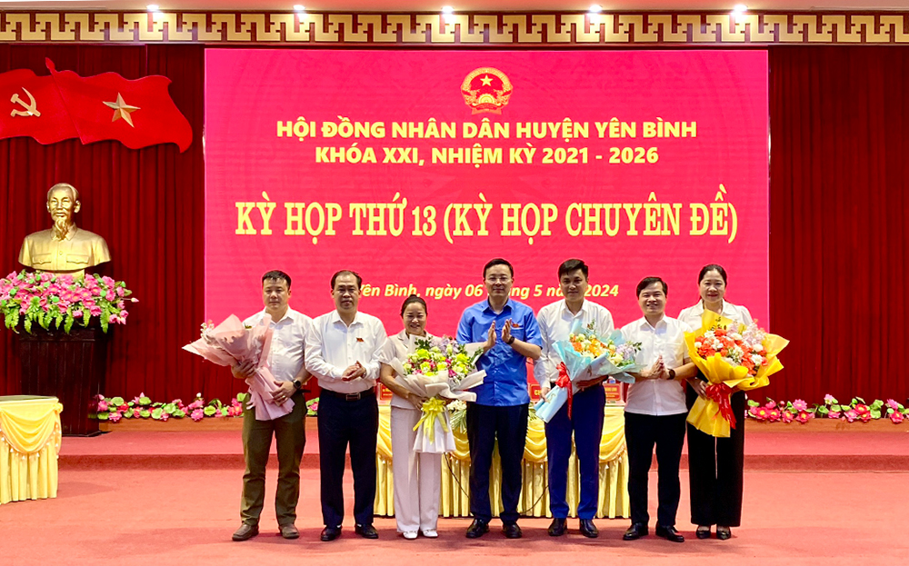 Các đồng chí trong Thường trực Huyện ủy Yên Bình tặng hoa chúc mừng các đồng chí vừa được bầu giữ các chức vụ HĐND, UBND huyện nhiệm kỳ 2021-2026.