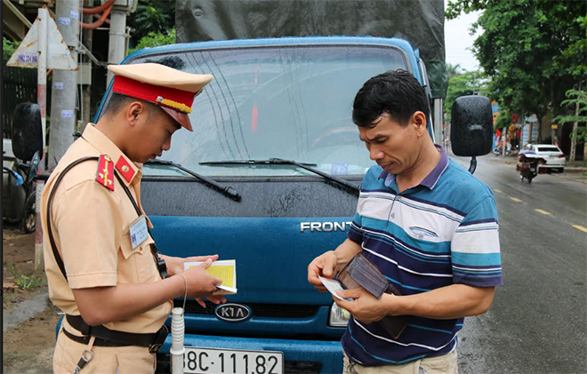 Cảnh sát giao thông Công an huyện Trấn Yên kiểm tra giấy tờ người điều khiển phương tiện.