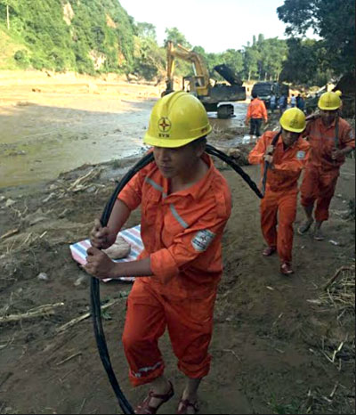Công nhân Điện lực Yên Bái xử lý sự cố đường dây tải điện trong vùng bị thiệt hại do mưa lũ.
