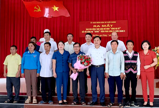 Lãnh đạo Sở Thông tin - Truyền thông và UBND huyện Văn Chấn tặng hoa chúc mừng mô hình “Dòng họ số” ở xã Suối Giàng