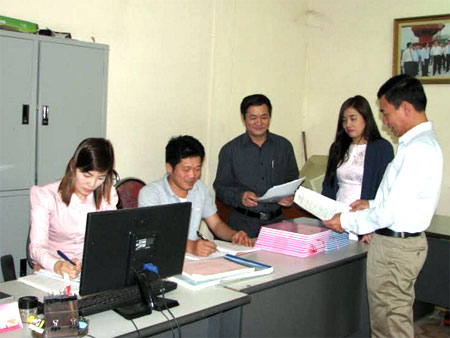 Cán bộ Phòng Tư pháp huyện Yên Bình trao đổi nội dung văn bản pháp luật mới ban hành.