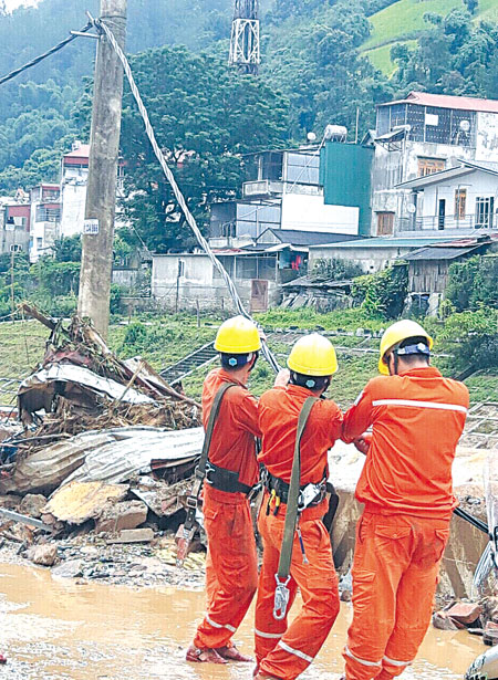 Công nhân Điện lực Nghĩa Lộ khắc phục hậu quả do lũ quét ở huyện Mù Cang Chải.

