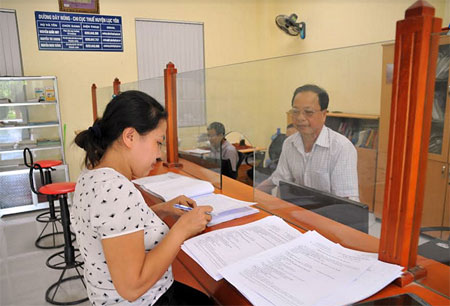 Người nộp thuế đến bộ phận một cửa Chi cục Thuế huyện Lục Yên làm thủ tục kê khai thuế.