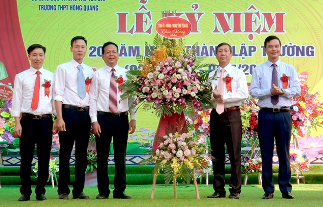 Các đồng chí: Nguyễn Văn Lịch - Trưởng ban Nội chính Tỉnh ủy, Dương Văn Tiến - Phó chủ tịch UBND tỉnh tặng hoa chúc mừng nhà trường.