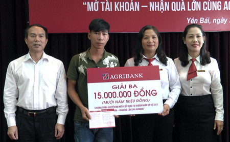 Đại diện Agribank Yên Bái  trao giải ba cho khách hàng Đặng Mạnh Quân, xã Đại Đồng, huyện Yên Bình