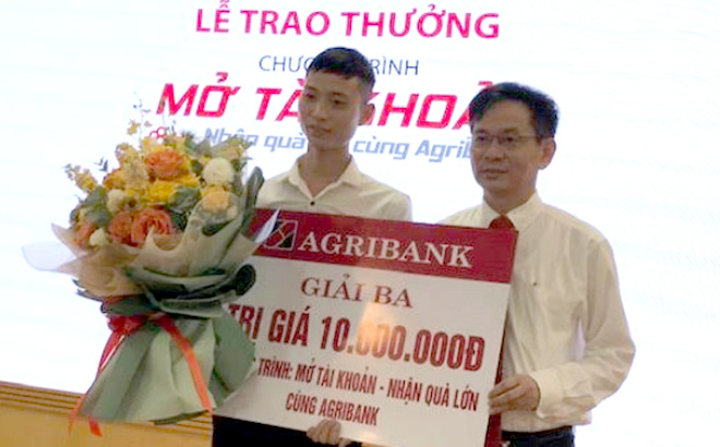 Lãnh đạo Agribank Chi nhánh Bắc Yên Bái trao thưởng cho khách hàng may mắn.