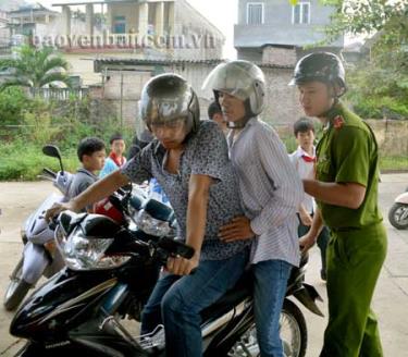 Đối tượng tình nghi (giữa) bị tóm gọn, áp giải về cơ quan công an.