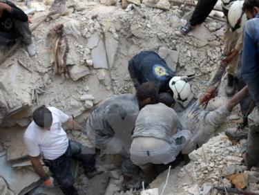 Tình nguyện viên Syria chuyển thi thể một nạn nhân sau một vụ không kích tại Aleppo ngày 4/10.