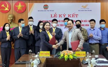 Chairman of the provincial Farmers' Association Giang A Cau and representatives of the provincial post office sign a contract to popularise and sell products of local farmers on e-commerce trading floors.