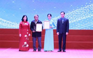 Bà Bùi Thị Minh Hoài - trưởng Ban Dân vận Trung ương và ông Nguyễn Đình Khang - chủ tịch Tổng liên đoàn Lao động Việt Nam - trao giải nhất cho các tác giả