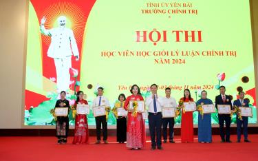 Đồng chí Phạm Tiến Hưng - Hiệu trưởng Trường Chính trị trao giải Nhất cho thí sinh Nguyễn Ngọc Lan.